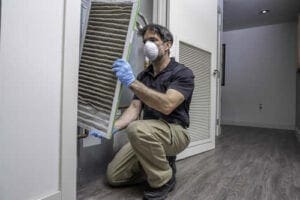 Furnace filter changeout by a furnace repairman